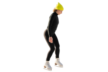A full-length woman is skating for ice. She is dressed in warm sports clothes and a yellow hat. Healthy lifestyle in winter.