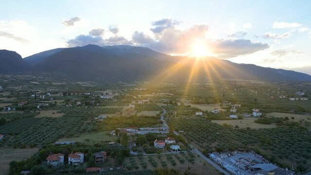 Aerial view of of Mount Olympus in Greece at sunset. Drone shot of the landscape of the ancient mountain of the gods, seasonal nature trip in an idyllic summer. Flying from the Leptokarya