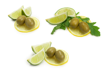 Two olives, piece of lemon and leaves of arugula isolated on white