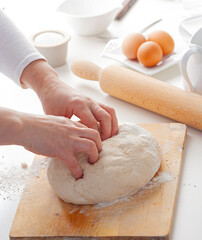 Hands of a person preparing pizza dough