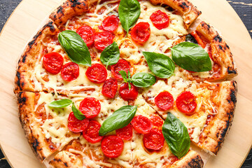 Wooden board with tasty pizza Margarita on table