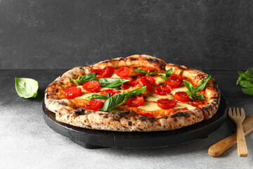 Wooden board with tasty pizza Margarita on table