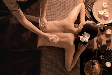 Young woman getting massage in dark spa salon, top view