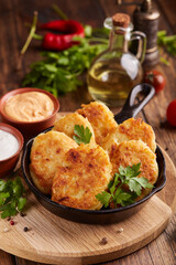 Hash browns. Pancakes from julienned potatoes. Vegetable patties. American cuisine, breakfast fritters, side dish, fast food.