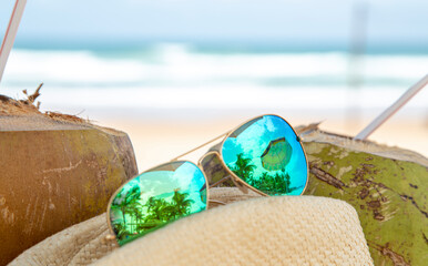 Chapéu de palha, óculos escuros, água de coco e praia do nordeste brasileiro