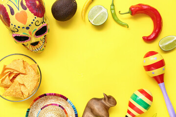 Frame made from Mexican food, maracas, sombrero and sugar skull on yellow background