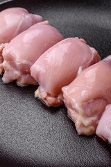 Fresh raw chicken thigh fillets with salt, spices and herbs