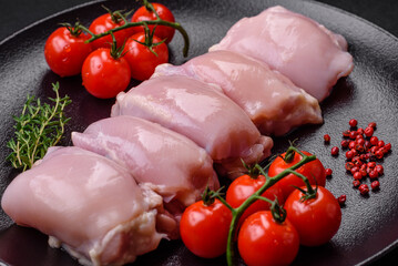 Fresh raw chicken thigh fillets with salt, spices and herbs