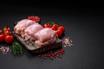 Fresh raw chicken thigh fillets with salt, spices and herbs