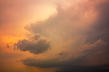Photo of rainy clouds and orange sky.