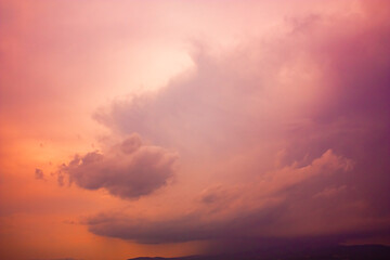 Naklejka na ściany i meble Photo of rainy clouds and pink sky.
