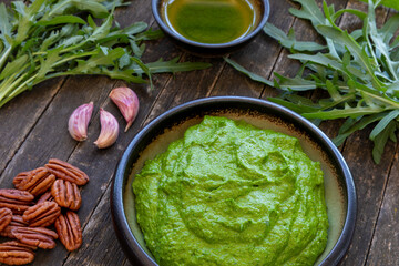Homemade arugula pesto dip with pecan nuts. Vegan cuisine.
