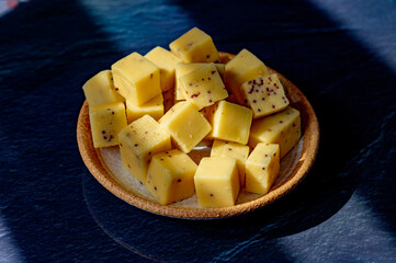 Cheese collection, matured yellow cow cheese with mustard seeds from Belgium