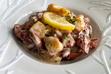 Tastes od Camargue, Provence, hot dish salad with boiled octopus, potatoes and white sauce, served in French restaurant