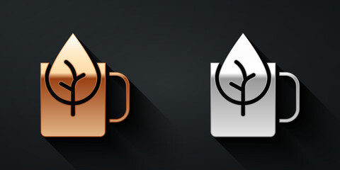 Gold and silver Cup of tea with leaf icon isolated on black background. Sweet natural food. Long shadow style. Vector