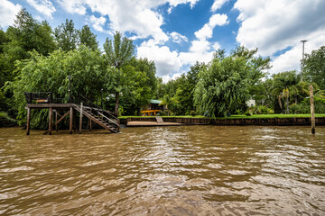 Boat tour on the Parana Delta, Tigre, Buenos Aires, Argentina. Palm trees, construction site of...