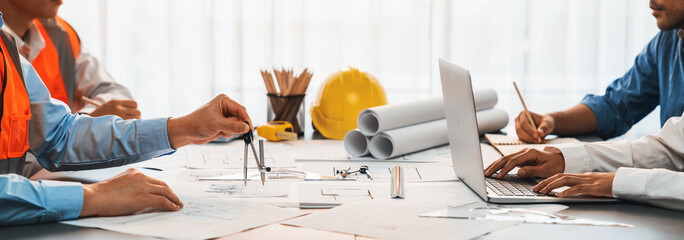 Architect or engineer working on building blueprint, contractor designing and drawing blueprint layout with tool for construction project. Civil engineer and architecture design concept. Insight - obrazy, fototapety, plakaty