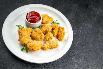 chicken nuggets deep-fried tomato sauce meat ready to eat meal food snack on the table copy space food background rustic top view