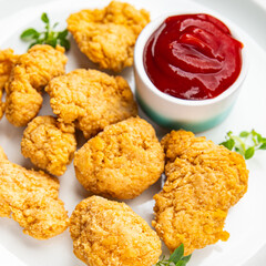 chicken nuggets deep-fried tomato sauce meat ready to eat meal food snack on the table copy space food background rustic top view