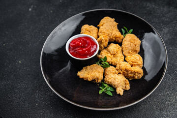 chicken nuggets deep-fried tomato sauce meat ready to eat meal food snack on the table copy space food background rustic top view