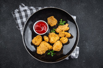 chicken nuggets deep-fried tomato sauce meat ready to eat meal food snack on the table copy space food background rustic top view