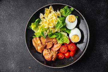 salad chicken liver, pasta, tomato, green leaf lettuce, boiled egg, farfalle snack meal food on the table copy space food background rustic top view