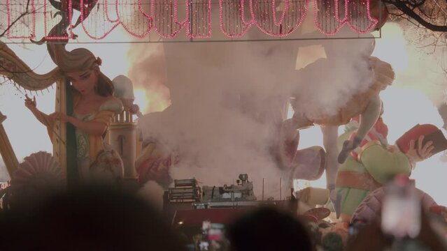 VALENCIA, SPAIN - MARCH 19, 2023: During the celebration of Fallas, bright Ninots decorate the streets, and at night they are accompanied by colorful fireworks, Spain, Valencia