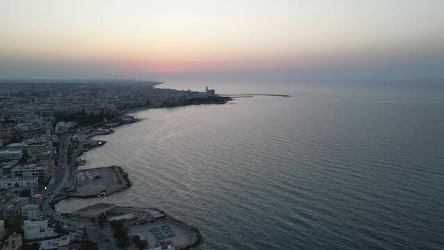 Aerial shot of the city of Trani at sunset. Marine location. Drone shot of the beach. Puglia
