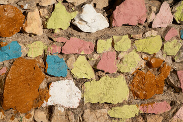 Old stone wall painted in various colors