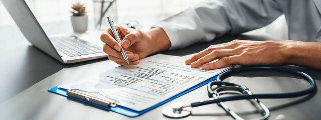 Doctor carefully review detailed medical report with laptop and diagnosing illness for effective...