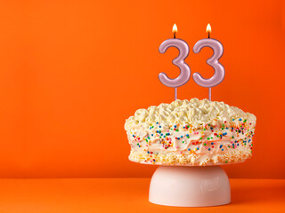 Candle number 33 - Vanilla cake in orange background