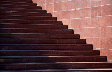 Obraz premium steps of an empty stone granite staircase close up