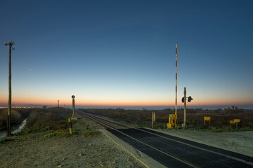 Sunrise image of a train level crossing