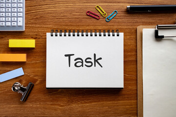 There is notebook with the word TASK. It is as an eye-catching image.