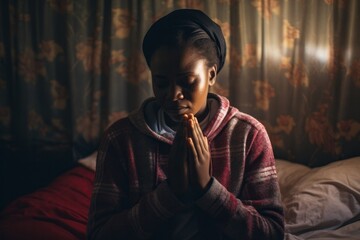 Expressive shot: a standing female aged 20 praying in her bed