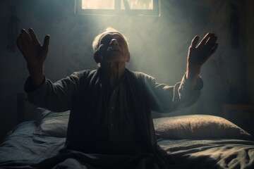 Emotive image of a standing female aged 80 praying in her bed