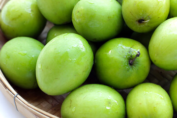 Green jujube fruits on white background.