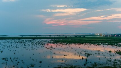 Reflective summer sunset on Mobile Bay