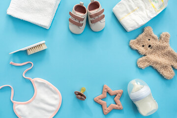 Top-down display of baby gear on calming blue