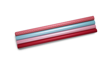 Rolls of colorful wrapping paper on white background, top view