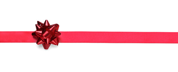 Red ribbon with bow on white background, top view