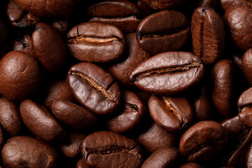 Aromatic roasted coffee beans as background, top view