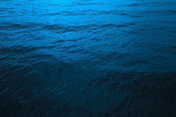 Black dark deep sea blue abstract background. Wavy water surface. Color gradient. Night. Reflection. Moon light. Ripple wave. Design. Template.