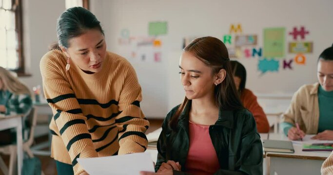 School, education and teacher help student in classroom for learning, check assignment and lesson. College, academy and educator explain to girl for question, teaching and studying for assessment
