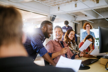 Diverse group of coworkers working together on a project in the office of a startup company