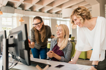 Young and diverse group of women working together in a startup company office