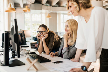 Young and diverse group of women working together in a startup company office