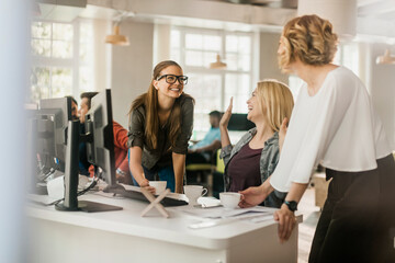 Young and diverse group of women working together in a startup company office