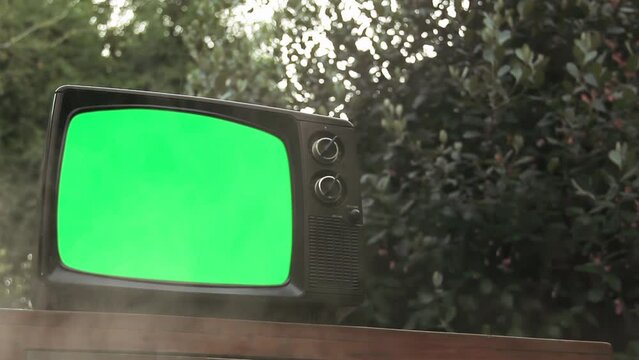 Vintage TV Green Screen and Smoke Outdoor. Close Up. You can replace green screen with the footage or picture you want with “Keying” effect in After Effects (check out tutorials on YouTube). 4K.