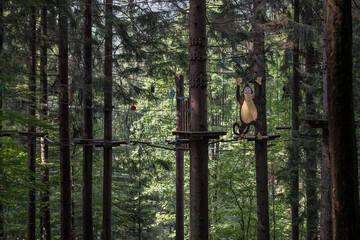 A rope attraction between the trees and a monkey figurine.